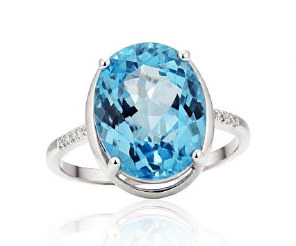 White gold ring with diamonds and blue topazes