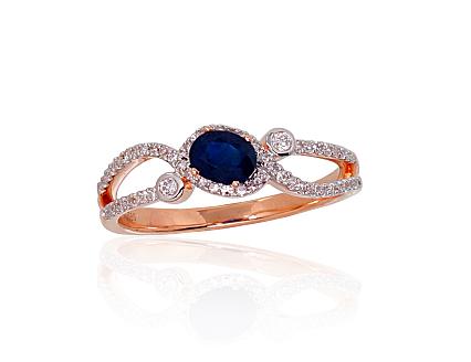 Red gold ring with diamonds and a sapphire